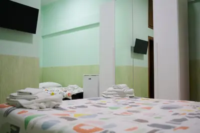 a bedroom with a bed with towels on it at On The Rainbow B&B in Rome