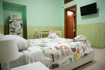 a bedroom with a bed with a colorful comforter at On The Rainbow B&B in Rome