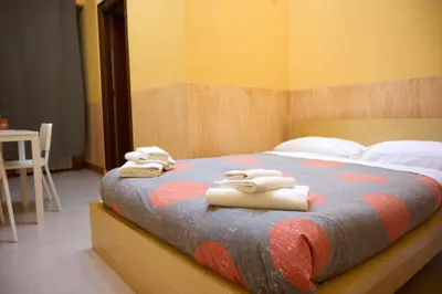 a bedroom with a bed with towels on it at On The Rainbow B&B in Rome
