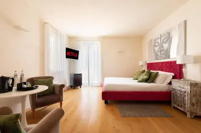 a bedroom with a bed and a table and a chair at Relais Clivo Vaticano in Rome