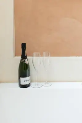 a bottle of wine and two glasses on a counter at Relais Clivo Vaticano in Rome