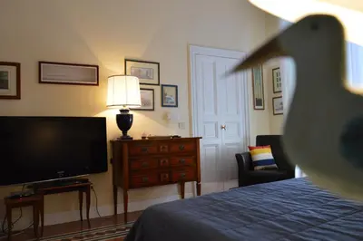 a bedroom with a tv and a bed and a dresser at Paola A Trastevere in Rome