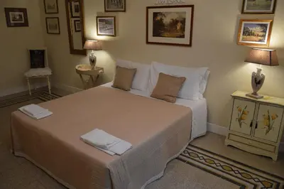 a bedroom with a large bed with two pillows at Paola A Trastevere in Rome