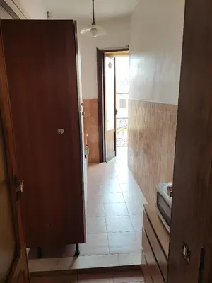 a room with a door and a hallway with a tile floor at Napoleone's House in Rome