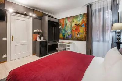 a bedroom with a red bed and a painting on the wall at Spanish Steps Art Gallery- Roma in Rome