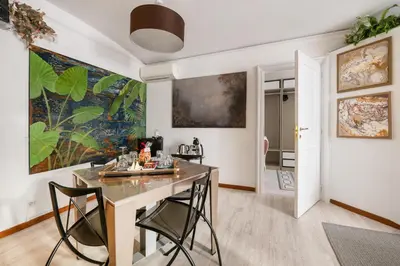 a dining room with a table and two chairs at Spanish Steps Art Gallery- Roma in Rome