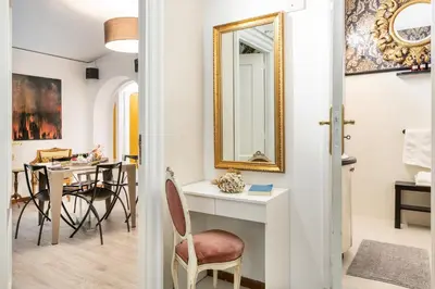 a living room with a table and a mirror at Spanish Steps Art Gallery- Roma in Rome