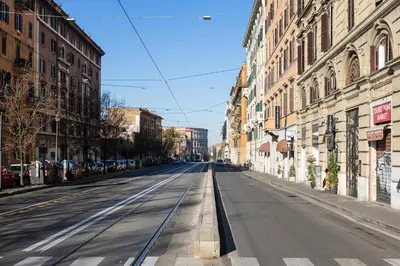 an empty street in a city with buildings at Luxury Stars In Rome - Andromeda apartment in Colosseum in Rome