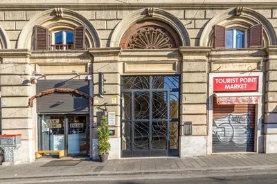 a building with a front entrance to a store at Luxury Stars In Rome - Andromeda apartment in Colosseum in Rome