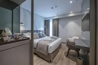 a hotel room with a bed and a desk at The Regency, Rome, a Tribute Portfolio Hotel in Rome