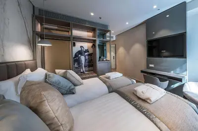 a bedroom with a large bed and a flat screen tv at The Regency, Rome, a Tribute Portfolio Hotel in Rome