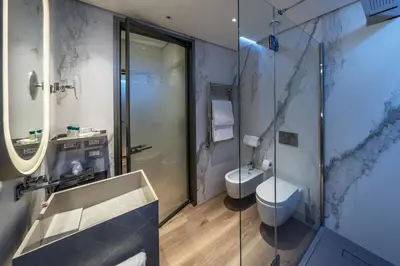 a bathroom with a sink and a shower at The Regency, Rome, a Tribute Portfolio Hotel in Rome
