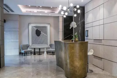 a lobby with a reception desk and a piano at The Regency, Rome, a Tribute Portfolio Hotel in Rome
