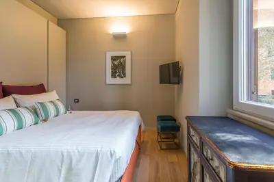a bedroom with a bed and a tv and a window at Casa Epiro in Rome