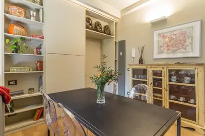 a kitchen with a table with a vase of flowers on it at Casa Epiro in Rome
