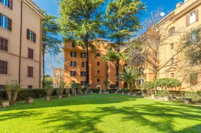 a green yard in front of two buildings at Casa Epiro in Rome