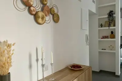 a room with a table and some plates on the wall at Central modern apartment Rome -Locazione Turistica- in Rome