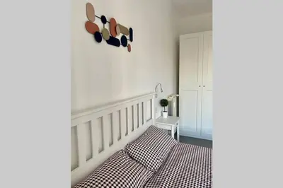 a bedroom with a bed and a clock on the wall at Central modern apartment Rome -Locazione Turistica- in Rome