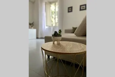 a living room with a table and a couch at Central modern apartment Rome -Locazione Turistica- in Rome