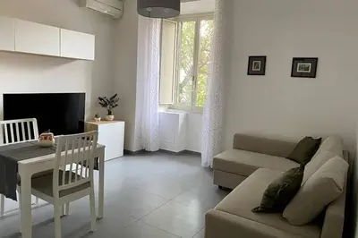 a living room with a couch and a table at Central modern apartment Rome -Locazione Turistica- in Rome