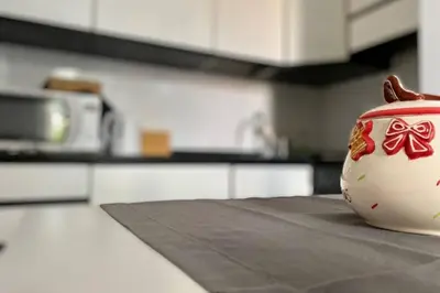 a red and white vase sitting on a counter in a kitchen at Central modern apartment Rome -Locazione Turistica- in Rome