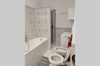 a bathroom with a tub and a toilet and a sink at Lanza Tomasi Apartment - centre in Rome