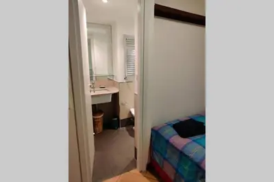 a bathroom with a bed and a sink and a mirror at Lanza Tomasi Apartment - centre in Rome