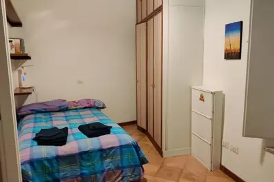 a bedroom with a bed and a dresser at Lanza Tomasi Apartment - centre in Rome