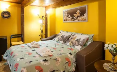a bedroom with a bed with a comforter on it at Wood Easy Flat in Rome