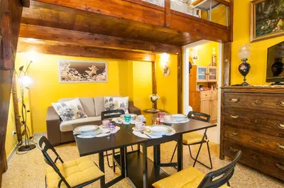 a living room with a table and a couch at Wood Easy Flat in Rome