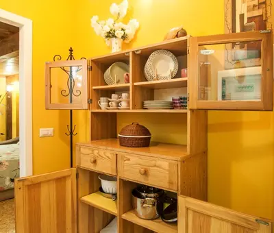 a room with a wooden cabinet with dishes on it at Wood Easy Flat in Rome