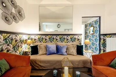 a couch with green pillows in a living room at Trevi Fountain Stylish Penthouse IREX Apartment in Rome
