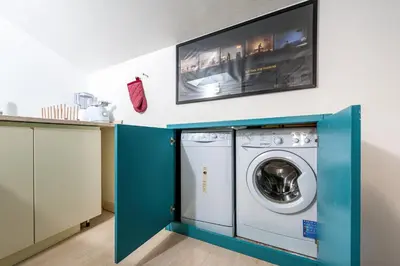 a laundry room with a washer and dryer at Trevi Fountain Stylish Penthouse IREX Apartment in Rome