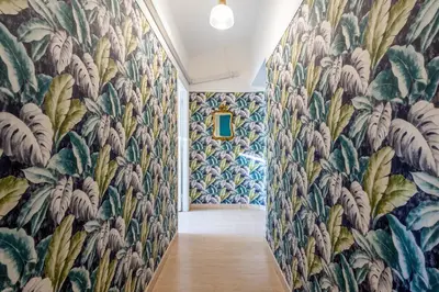 a hallway with a wall of floral wallpaper at Trevi Fountain Stylish Penthouse IREX Apartment in Rome