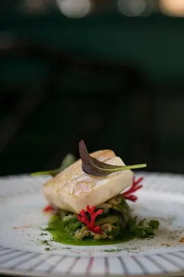 a piece of food sitting on a white plate at Maalot Roma - Small Luxury Hotels of the World in Rome