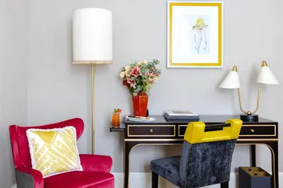a room with a desk and a chair and a table with a lamp at Maalot Roma - Small Luxury Hotels of the World in Rome