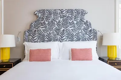 a bedroom with a large bed with two lamps at Maalot Roma - Small Luxury Hotels of the World in Rome