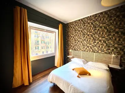 a bedroom with a large bed and a window at Prati Comfort in Rome