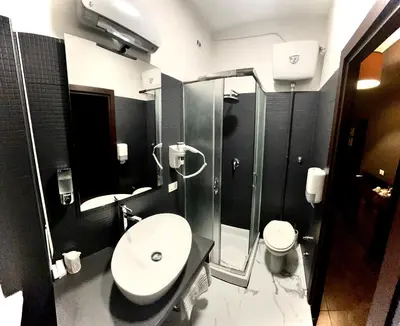 a bathroom with a sink and a shower and a toilet at Prati Comfort in Rome