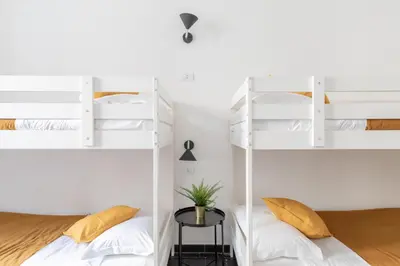 a bedroom with two bunk beds and a table at iFlat Lovely Apartment for Groups in Rome