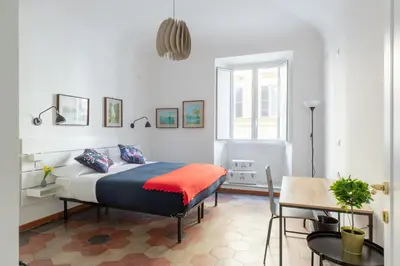 a bedroom with a bed and a table in it at iFlat Lovely Apartment for Groups in Rome