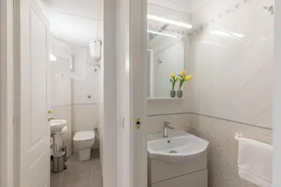 a white bathroom with a sink and a toilet at iFlat Lovely Apartment for Groups in Rome