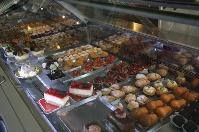 a display case with many different desserts and pastries at Biancorè in Rome