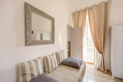 a living room with a mirror and a couch at Biancorè in Rome