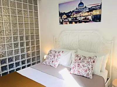 a room with a white bed with pillows on it at THE ROMAN WAY Museum in Rome