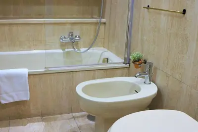 a bathroom with a toilet and a sink and a tub at THE ROMAN WAY Museum in Rome