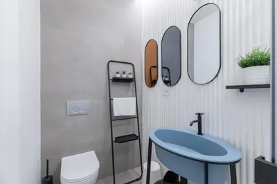 a bathroom with a blue sink and mirrors at Twin Flowers apartment in San Giovanni in Rome