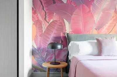 a bedroom with a bed with a pink wallpaper at Twin Flowers apartment in San Giovanni in Rome