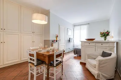 a kitchen and dining room with a table and chairs at Rome As You Feel - Paradiso Apartment in Rome