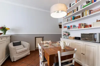 a kitchen and dining room with a table and chairs at Rome As You Feel - Paradiso Apartment in Rome